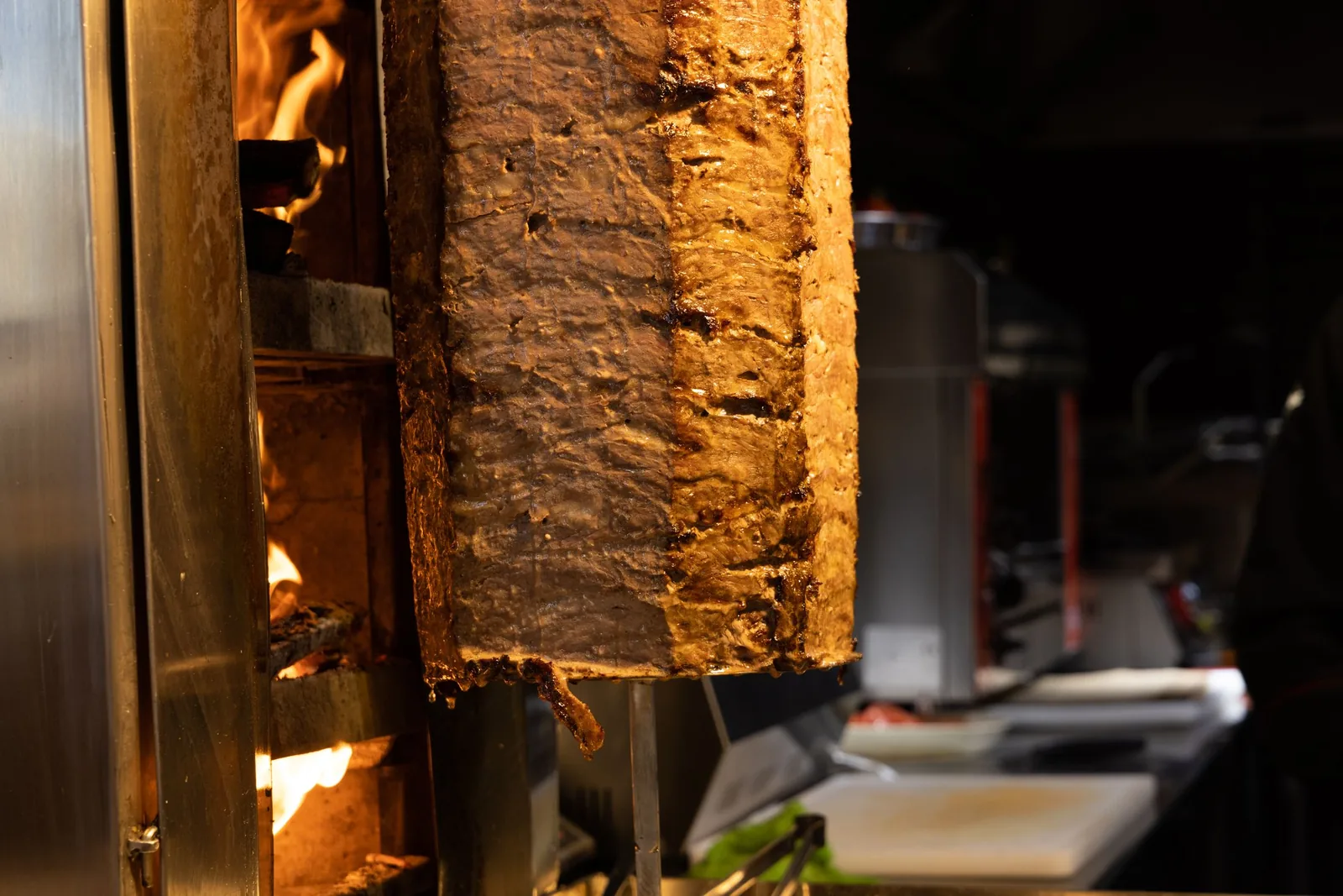 The shawarma spit glowing in a dark kitchen